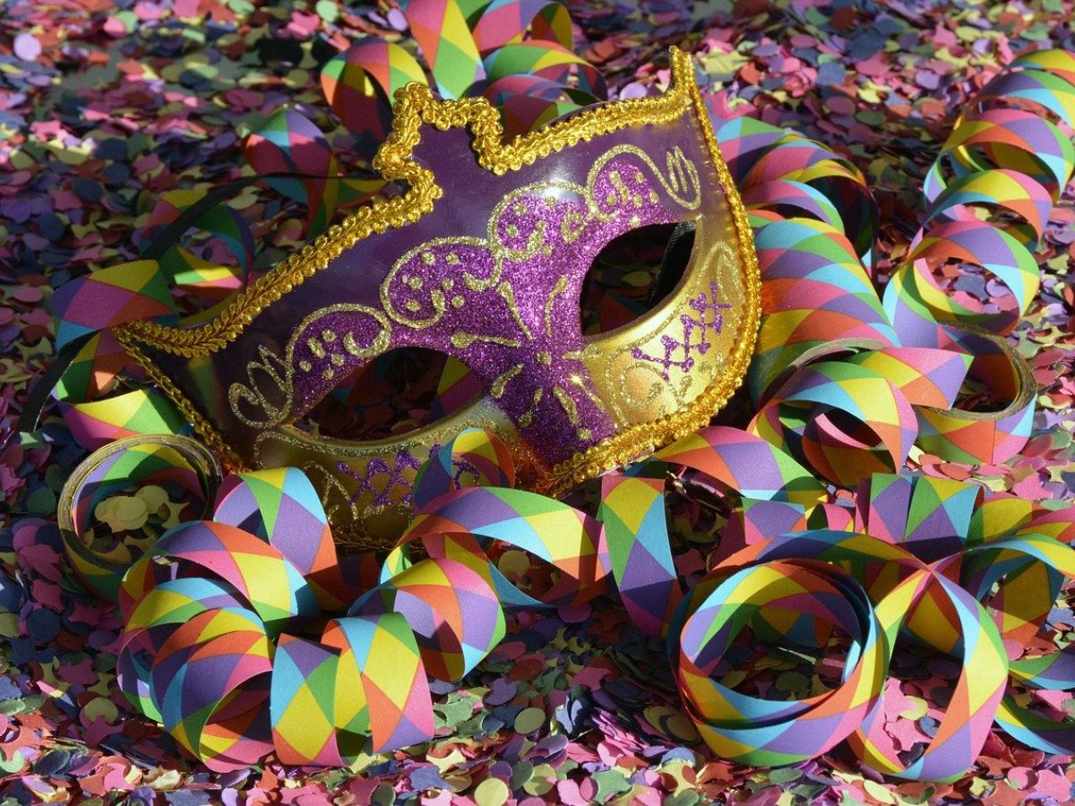 A colorful Mardi Gras mask surrounded by confetti.
