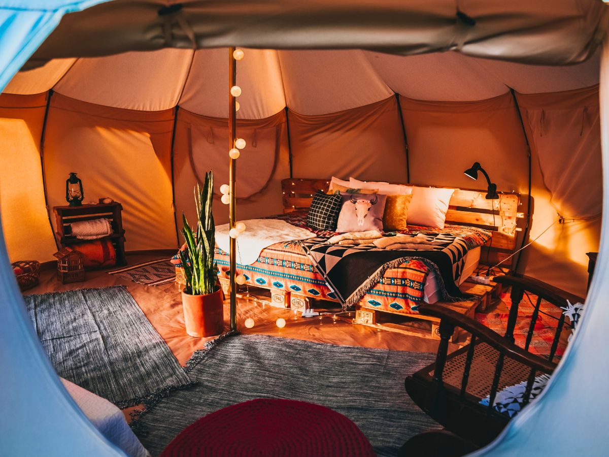 The inside of a luxury tent with a bed inside.