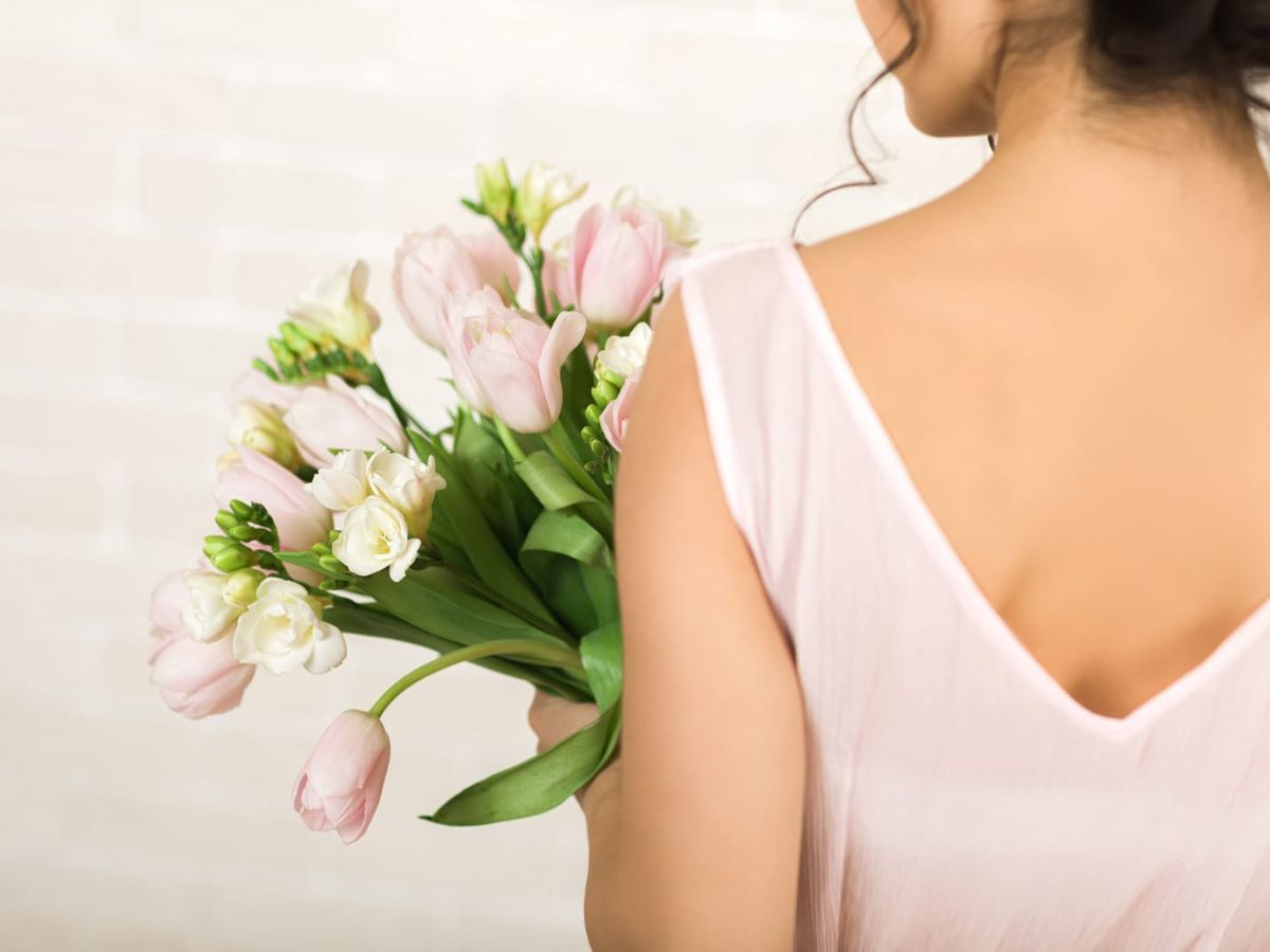 A bride holding a bouquet of tulips.