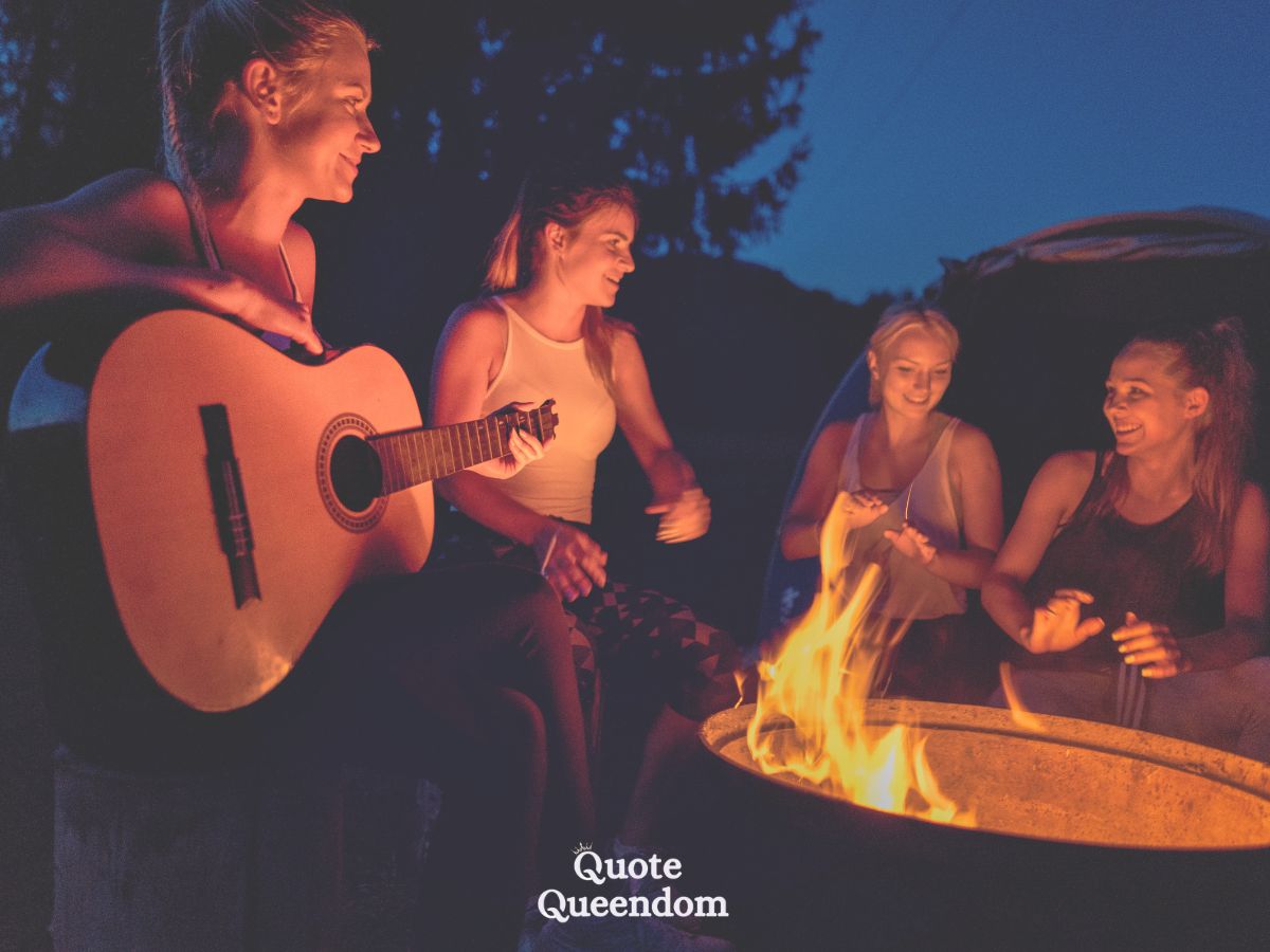 Friends enjoying a campfire sing-along at night.